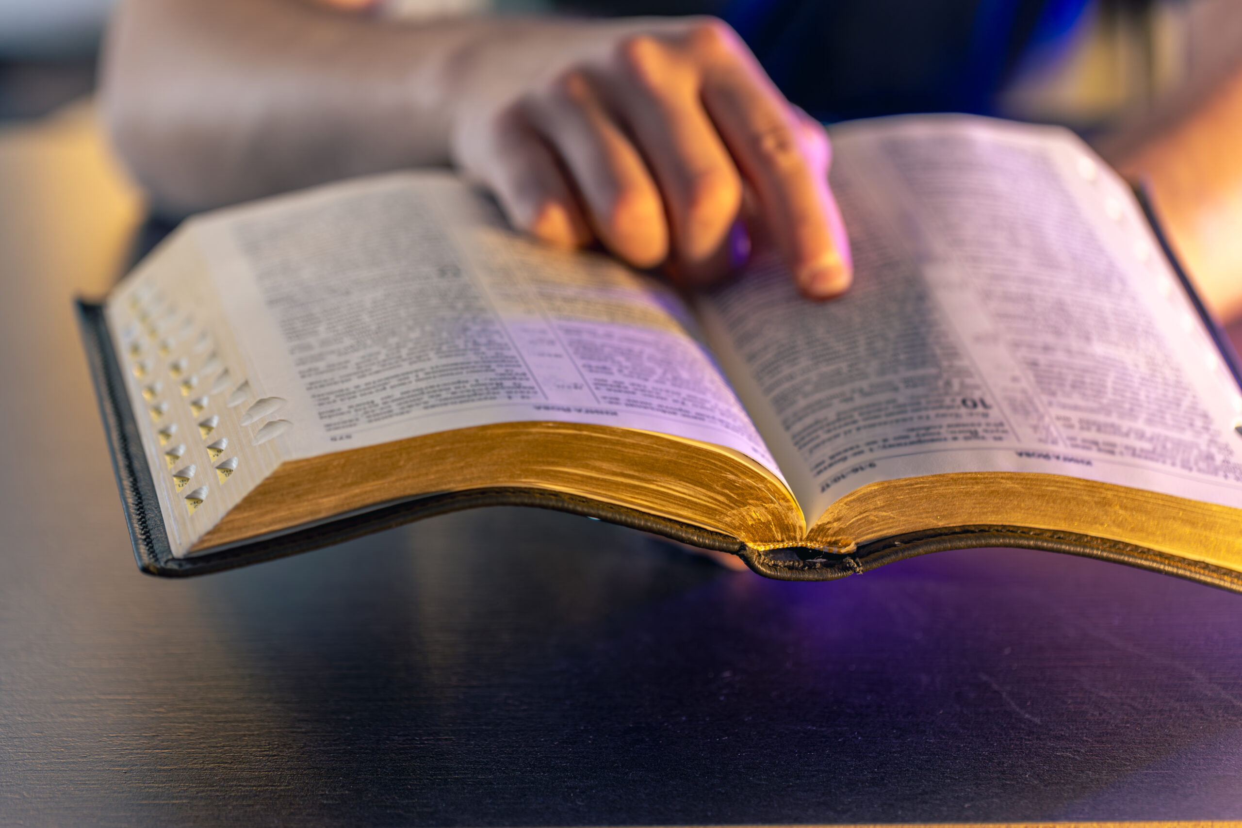 a man reads the bible. male hands on the holy bible. close up of the bible.